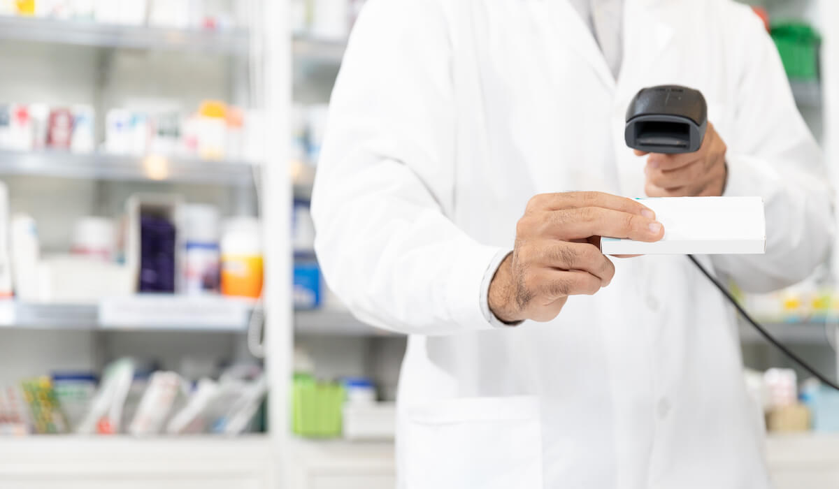 Pharmacist using barcode scanner. 